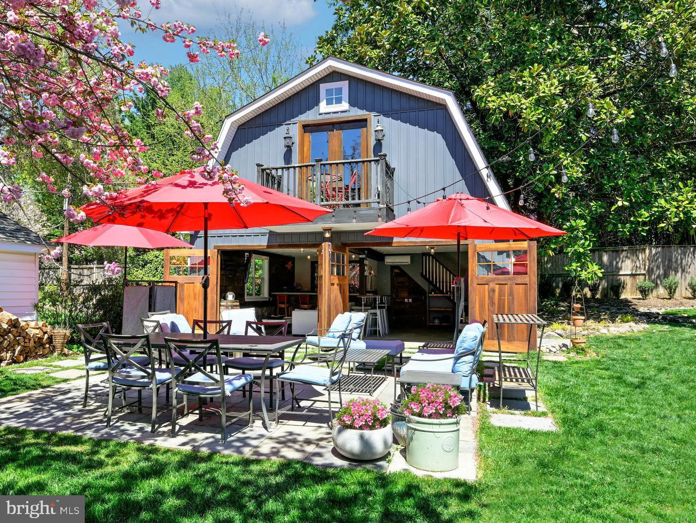 a view of a cafe with a yard and lawn chairs