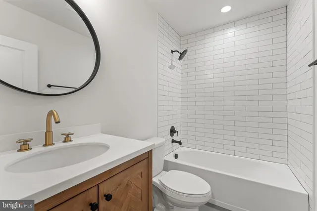 an empty room with an entryway and fan