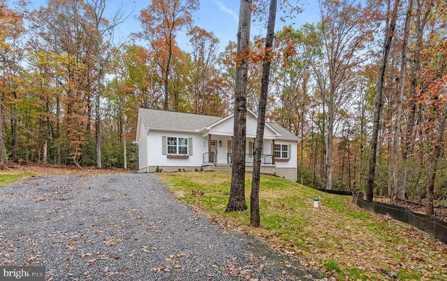 a front view of a house with yard patio and outdoor seating