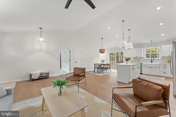 a living room with furniture and kitchen view
