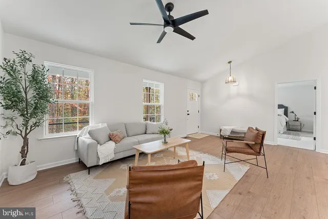 a living room with furniture and kitchen view