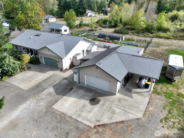 an aerial view of a house with yard and parking