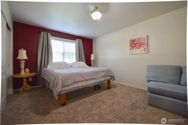 a bedroom with a bed and window