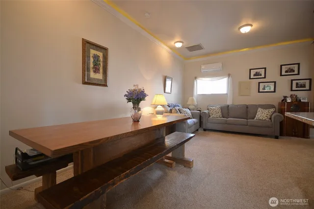 a view of a hallway with kitchen and dining room