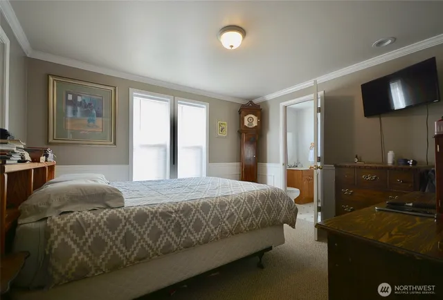 a bed room with a bed and a dresser