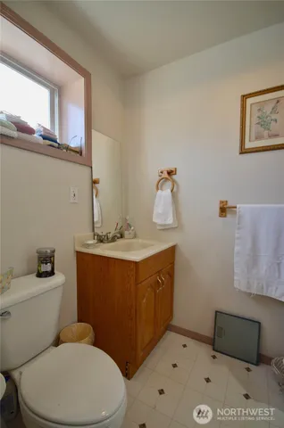 a bedroom with a bed next to a window