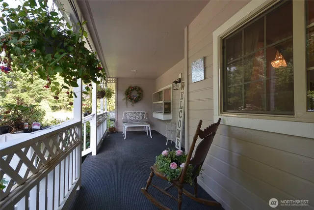 a porch with chairs and wooden fence