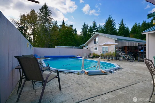 a view of a patio with table and chairs under an umbrella