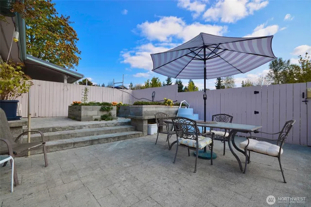 an aerial view of a house with a yard and lake view