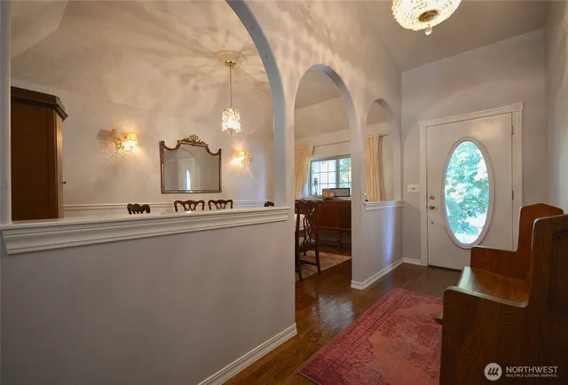 a view of a livingroom with furniture a window and wooden floor