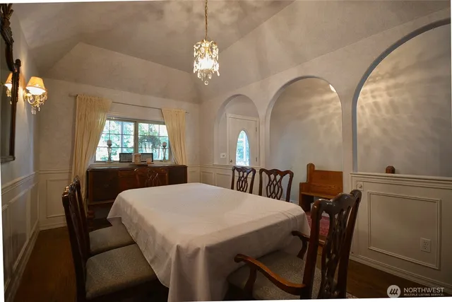 a view of a dining room with furniture and chandelier