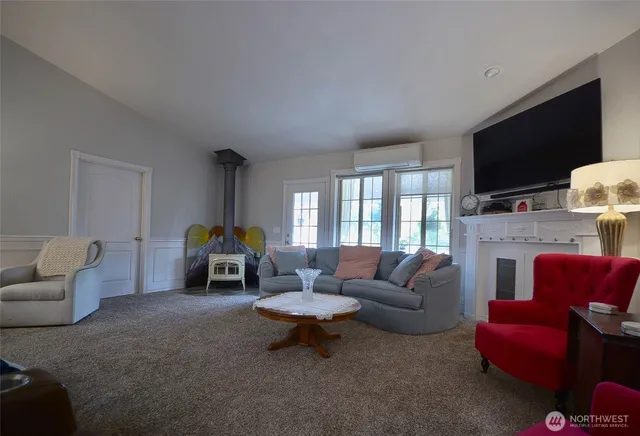 a living room with furniture a flat screen tv and a fireplace