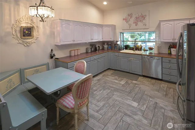 a kitchen with a sink appliances and cabinets