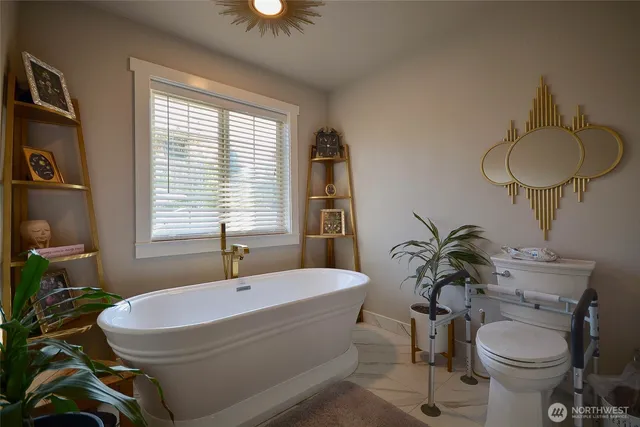 a bathroom with a toilet sink and mirror