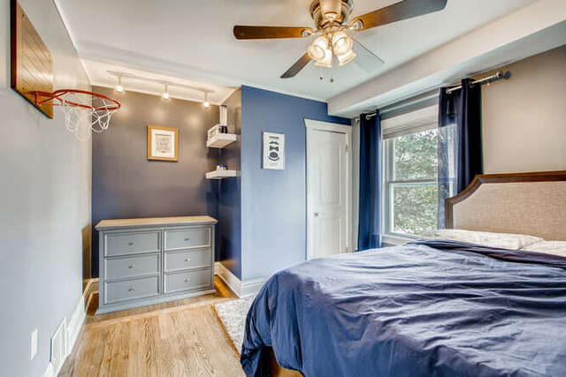 126 Southcote Road Riverside, IL 60546 - Photo 15 of 31 a bedroom with a bed and a chandelier