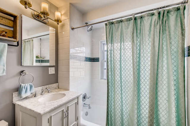 126 Southcote Road Riverside, IL 60546 - Photo 19 of 31 a bathroom with a granite countertop sink a mirror and a shower