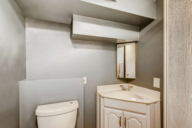 126 Southcote Road Riverside, IL 60546 - Photo 24 of 31 a bathroom with a sink a toilet and mirror