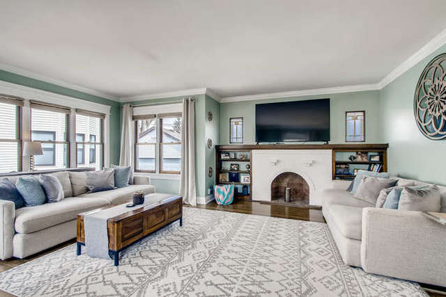 126 Southcote Road Riverside, IL 60546 - Photo 4 of 31 a living room with furniture a flat screen tv and a fireplace