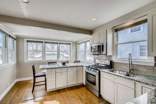 126 Southcote Road Riverside, IL 60546 - Photo 8 of 31 a kitchen with a sink stove and cabinets