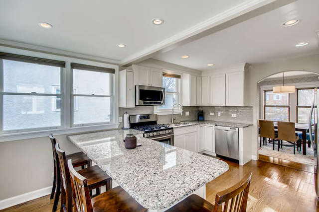 126 Southcote Road Riverside, IL 60546 - Photo 10 of 31 a kitchen with a stove a sink a dining table and chairs
