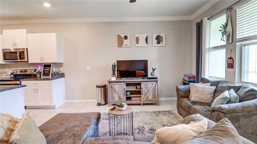 31632 Blue Passing Loop Wesley Chapel, FL 33545 - Photo 23 of 48 a living room with furniture and a flat screen tv