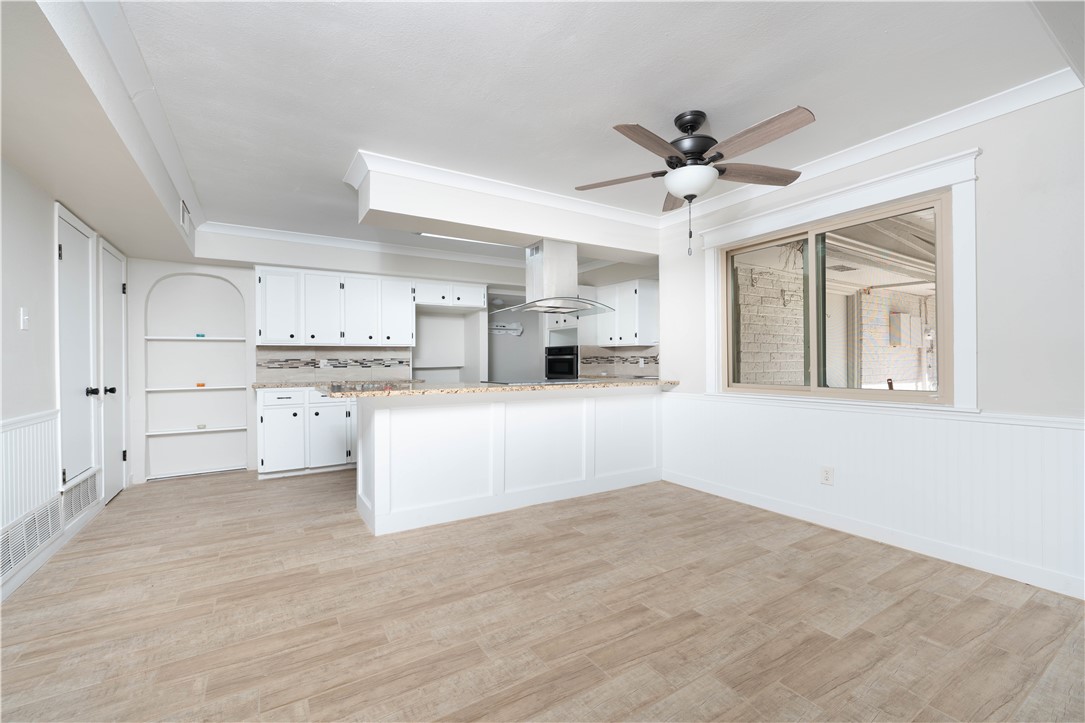 6402 Clearlake Circle Corpus Christi, TX 78413 - Photo 11 of 29 a view of kitchen with wooden cabinet and a window