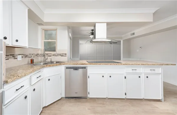 a kitchen with granite countertop white cabinets white appliances and granite counter tops