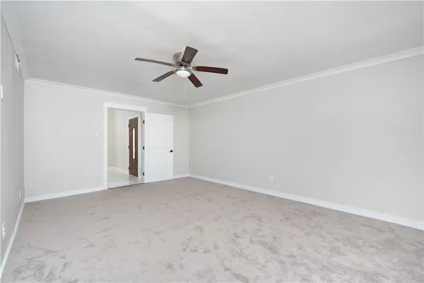 a view of empty room with ceiling fan