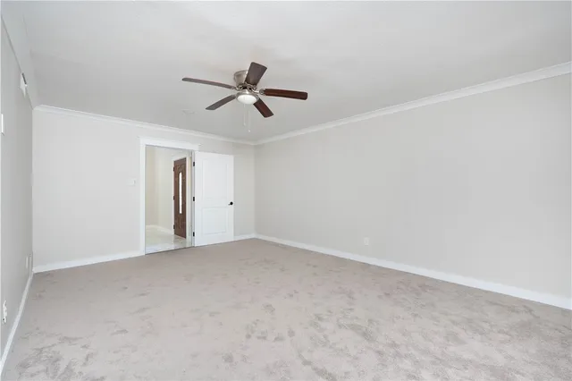 a view of empty room with ceiling fan