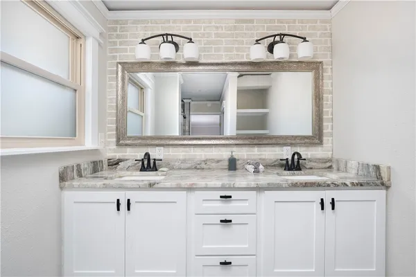 a view of a hallway with windows and stairs