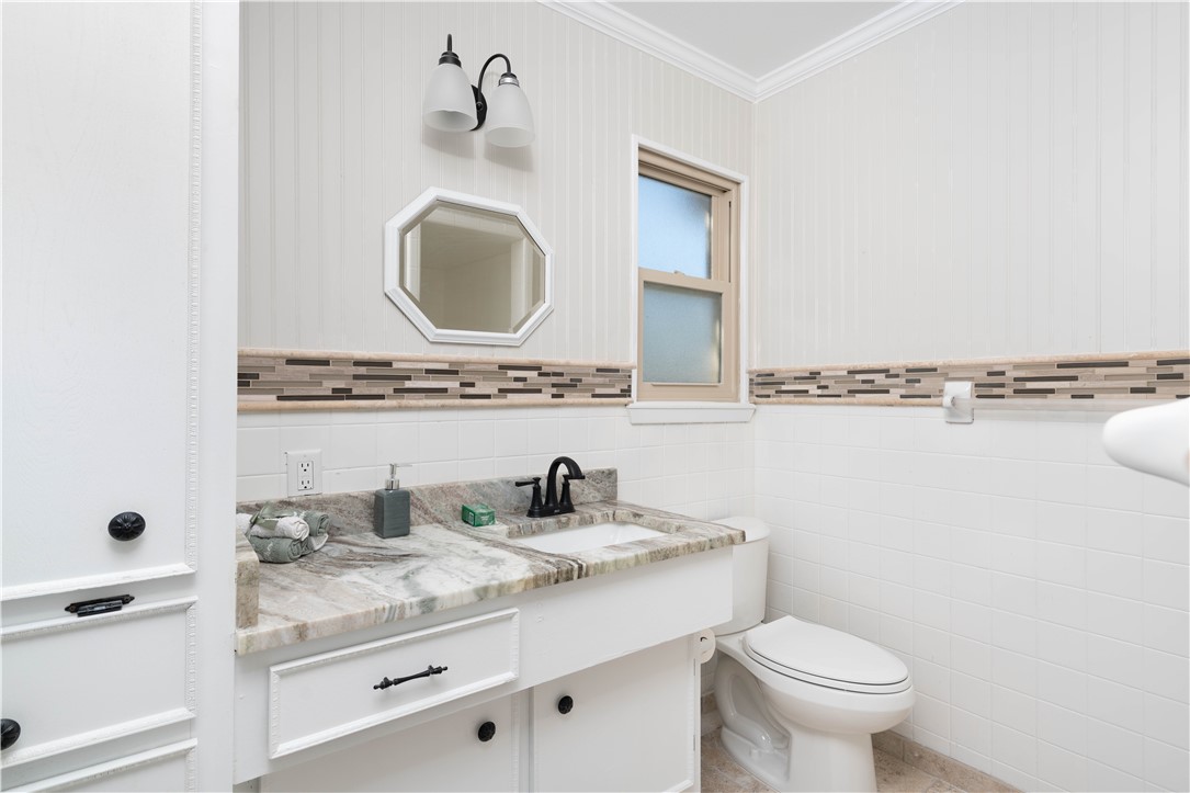6402 Clearlake Circle Corpus Christi, TX 78413 - Photo 22 of 29 a bathroom with a toilet sink and mirror