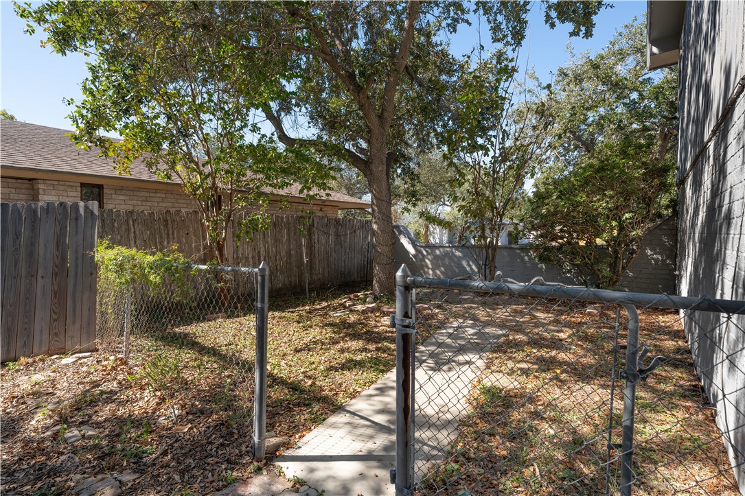 6402 Clearlake Circle Corpus Christi, TX 78413 - Photo 29 of 29 a backyard of a house with a tree