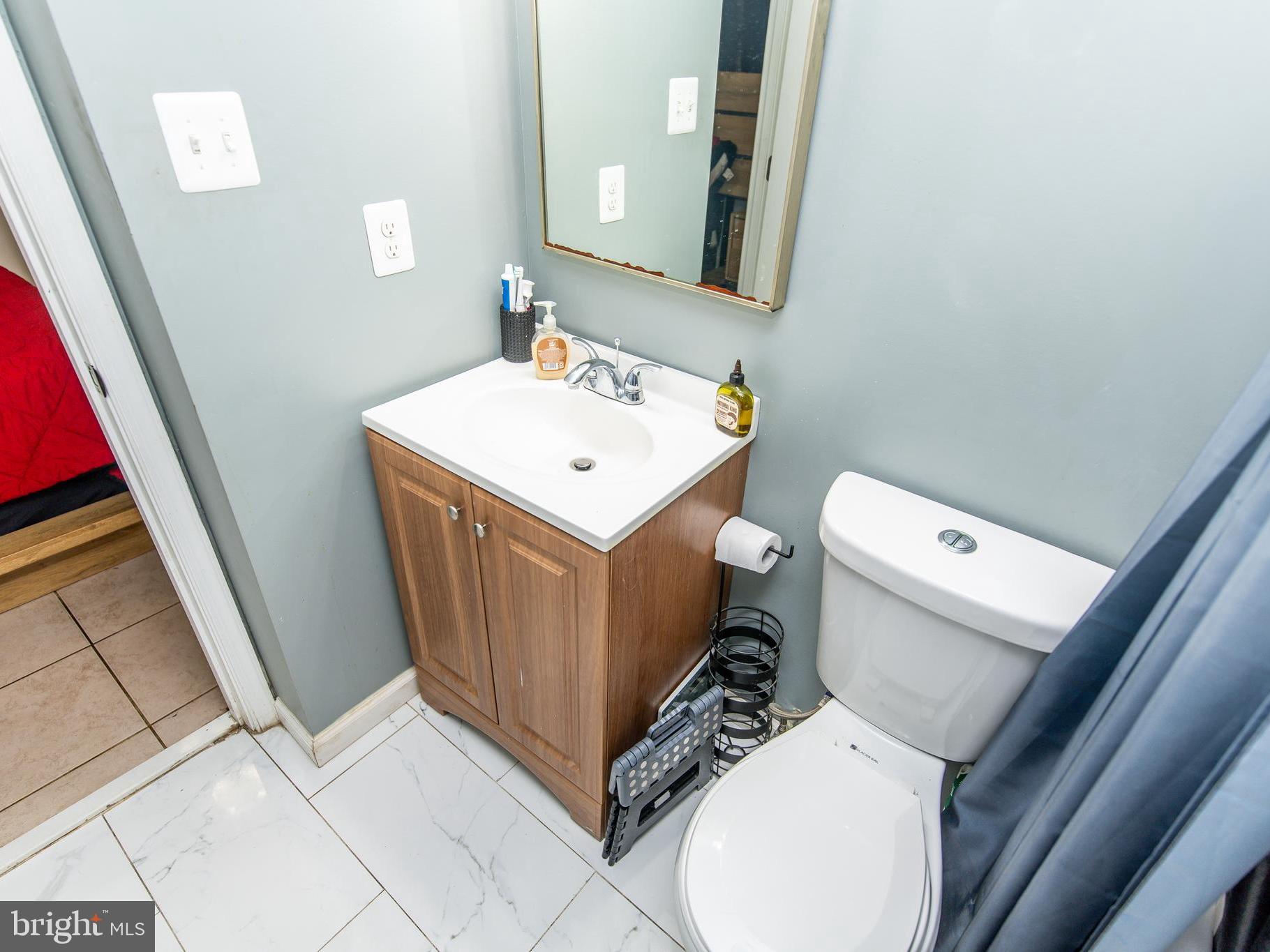 3934 Bel Pre Road, Unit 39342 Silver Spring, MD 20906 - Photo 13 of 30 a bathroom with a sink toilet and mirror