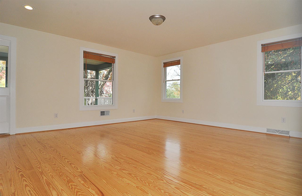 4651 Garth Road Charlottesville, VA 22901 - Photo 4 of 35 a view of an empty room with wooden floor and a window