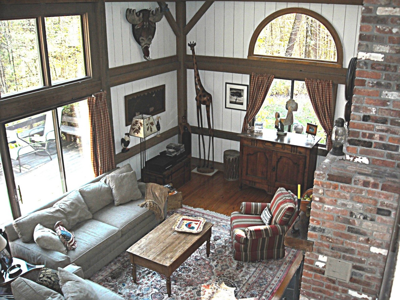 210 Hupi Road Monterey, MA 01245 - Photo 2 of 39 a living room with furniture a fireplace and a floor to ceiling window