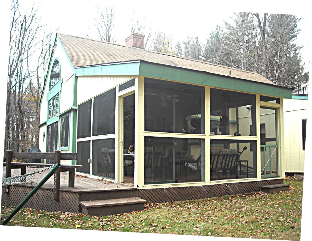 210 Hupi Road Monterey, MA 01245 - Photo 23 of 39 a view of a house with a large window and wooden fence