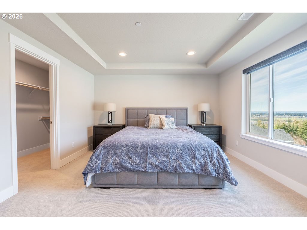 9149 North Hargrave Street Camas, WA 98607 - Photo 12 of 36 a spacious bedroom with a bed and a large window