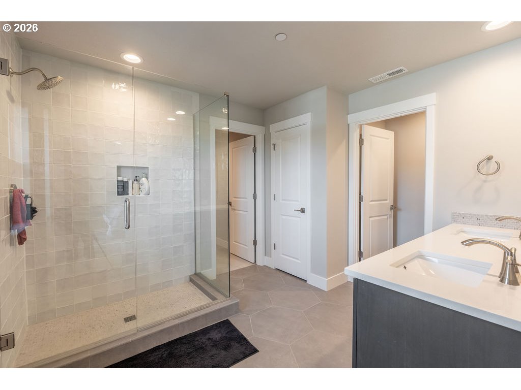 9149 North Hargrave Street Camas, WA 98607 - Photo 16 of 36 a bathroom with a shower sink and mirror