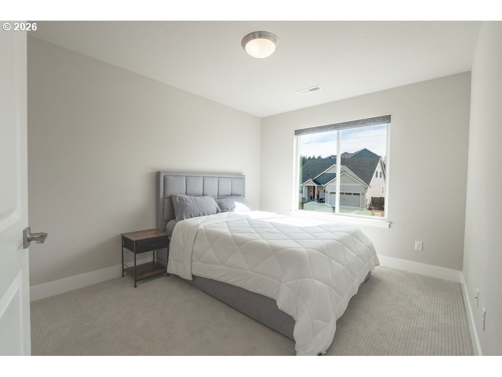 9149 North Hargrave Street Camas, WA 98607 - Photo 19 of 36 a bedroom with a bed and a window