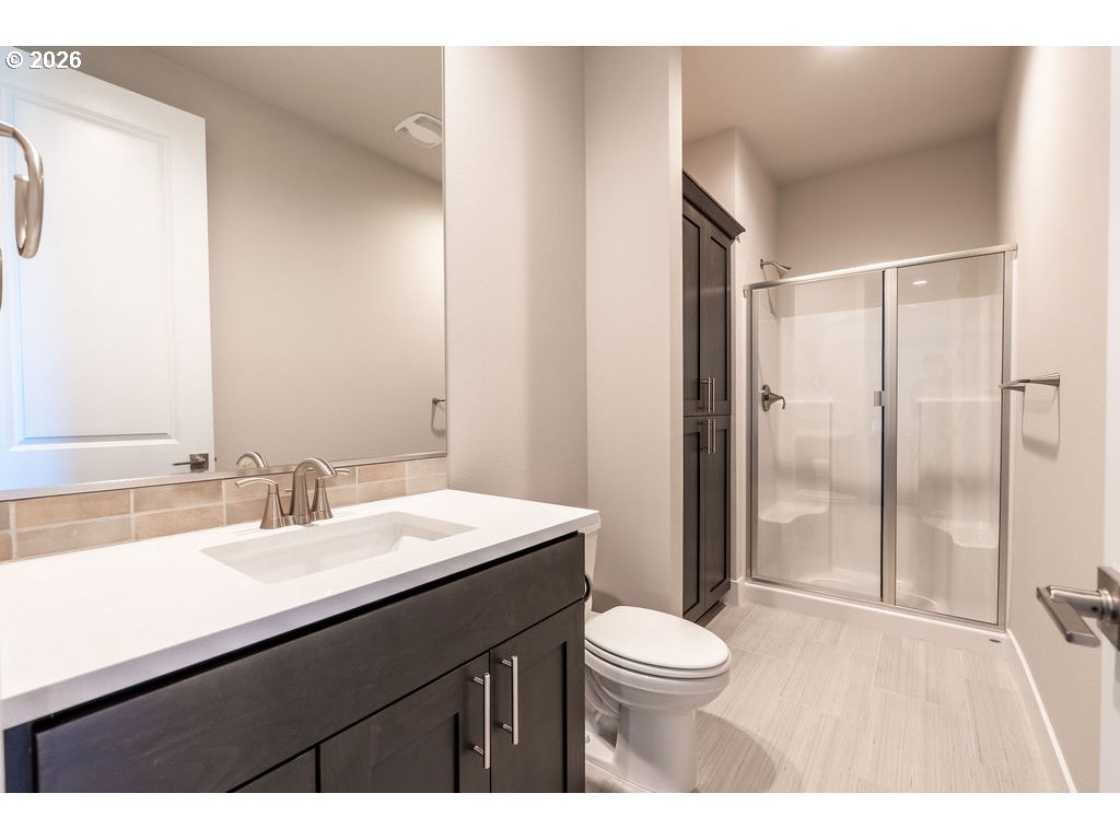 9149 North Hargrave Street Camas, WA 98607 - Photo 26 of 36 a bathroom with a sink a toilet a mirror and shower