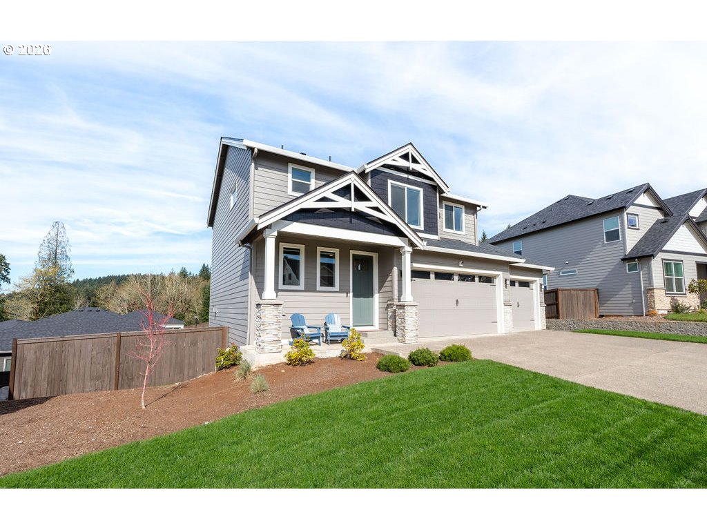 9149 North Hargrave Street Camas, WA 98607 - Photo 3 of 36 a front view of a house with a garden and yard
