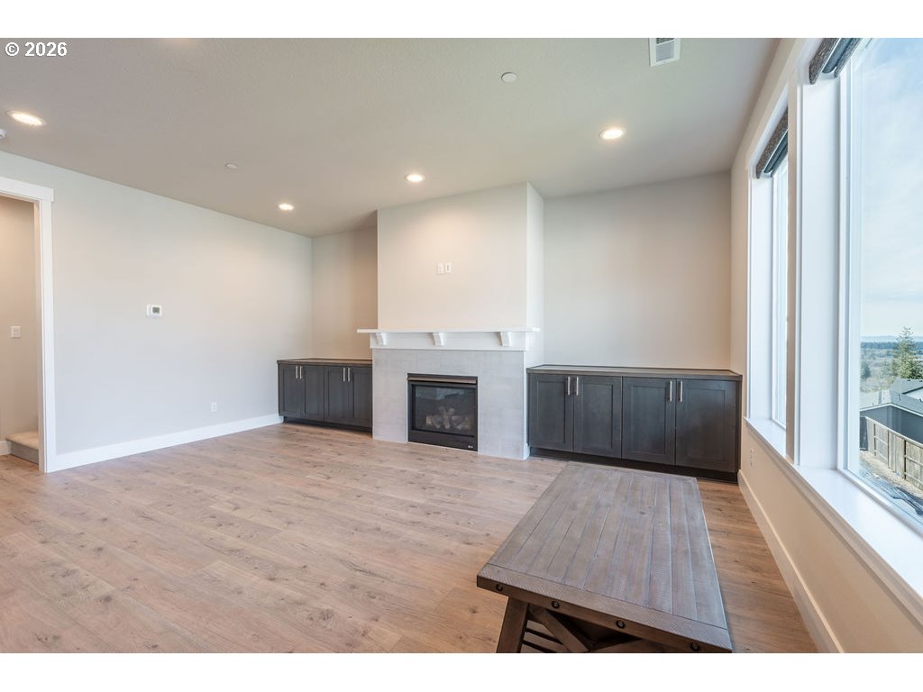 9149 North Hargrave Street Camas, WA 98607 - Photo 4 of 36 a view of empty room with wooden floor and fireplace