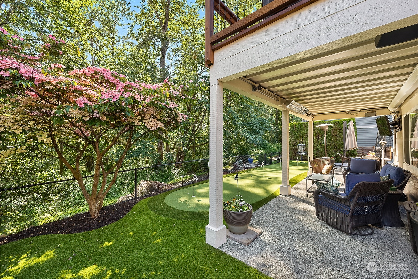 18564 Rainier View Road Southeast Monroe, WA 98272 - Photo 31 of 34 a view of a patio with table and chairs potted plants and large tree