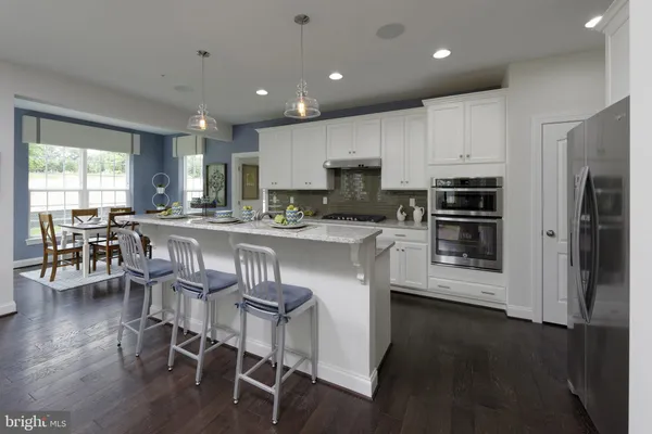a kitchen with stainless steel appliances granite countertop a stove refrigerator sink and cabinets