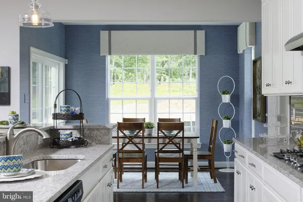 a kitchen with granite countertop a sink and a stove