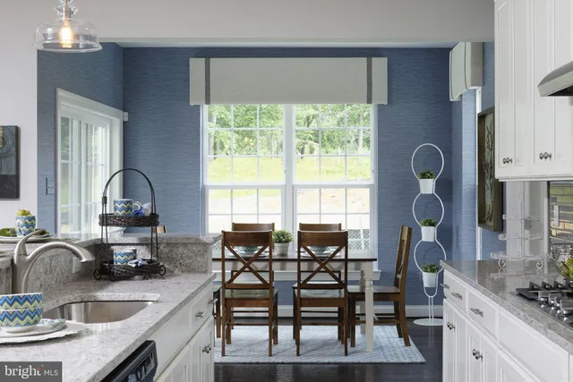 a kitchen with granite countertop a sink and a stove
