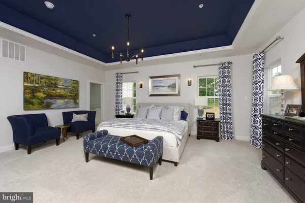 a spacious bedroom with a bed and furniture