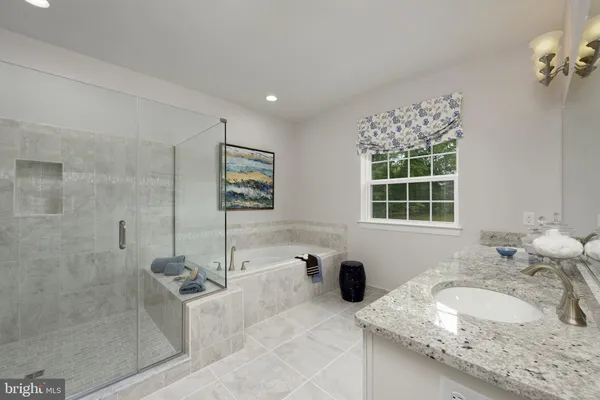 a bathroom with a granite countertop sink mirror and shower