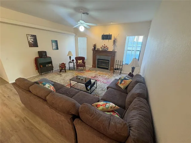 a view of a livingroom with furniture and a table chairs