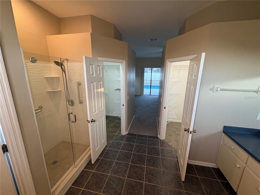 2810 Highview Bend Lakeland, FL 33812 - Photo 21 of 35 a bathroom with a glass door shower a sink and a mirror